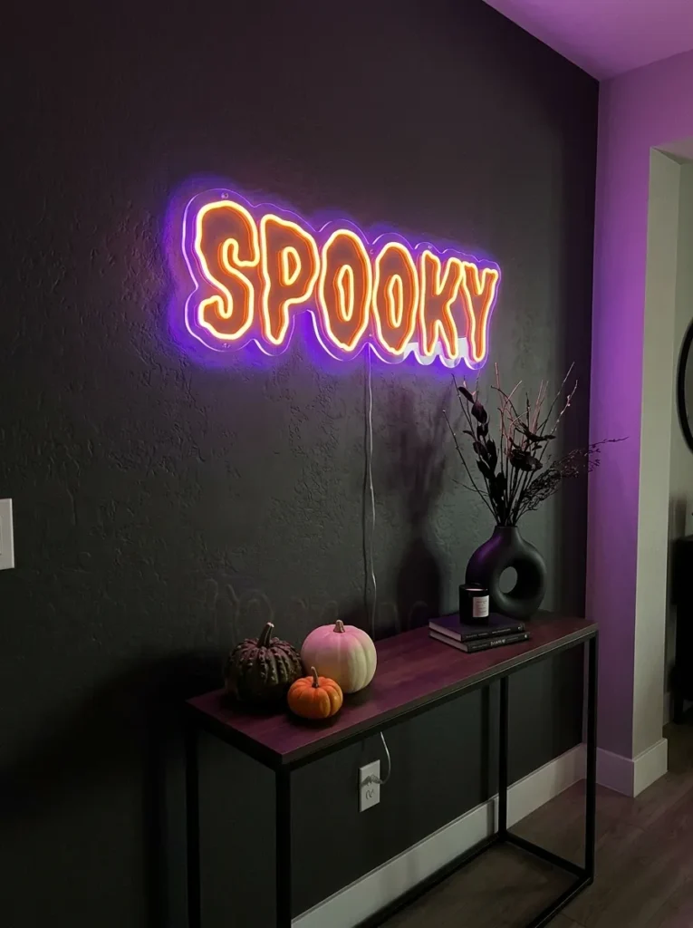 Vibrant LED Neon Spooky Word Art - halloween signs (Bright electric purple and orange silicone LED neon word art signs glowing in front window)